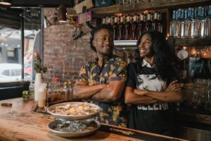 man and woman at an oyster bar enjoying slow travel
